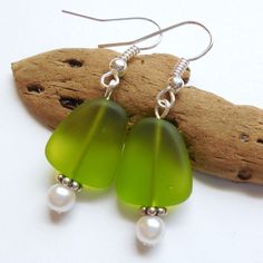 Lime Green Sea Glass Earrings,Sea Glass Jewelry,Seaglass Earrings,Seaglass Jewelry,Beach Glass Jewelry,Beach Glass Earrings,Beach Jewelry. Handmade dangle earrings feature a 15 mm Lime Green recycled sea glass flat bead and a 4mm pearl.  These earrings are a pretty translucent green color and are available in earwire, earpost or clip on.  Specify your choice of style: Earwire, Earpost or Clip on.  Upgrade all non-decorative silver to Sterling Silver for an additional charge of $6: https://www.et Sea Glass Teardrop Earrings For Beach, Beach Earrings With Sea Glass And Ear Wire, Beach Sea Glass Earrings With Ear Wire, Green Recycled Glass Earrings For Beach, Nickel-free Green Earrings For Beach, Beach Earrings With Recycled Glass And Ear Wire, Glass Dangle Earrings For The Beach, Beads Inspiration, Beach Glass Jewelry