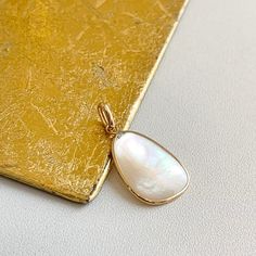 Estate 14KT yellow gold iridescent mother of pearl oblong/ abstract shaped pendant charm. Bail opening: 3mm No chain included Both sides are mother of pearl Measures: 25 x 14mm Not stamped, but guaranteed Mother Of Pearl Pendant, Pearl Pendant, Mother Of Pearl, Yellow Gold, Chain, Pendant, Yellow, Gold