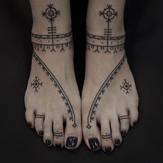 two feet with tattoos on them