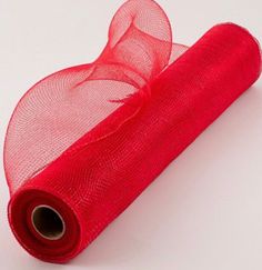 a roll of red tulle sitting on top of a table