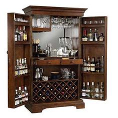 a wooden cabinet with wine glasses and liquor bottles