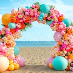 an arch made out of balloons and flowers on the beach