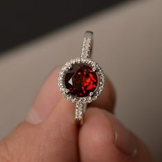 This is a gorgeous handmade creation. Its beauty is its simplicity & Elegance. The 7*7mm round cut natural garnet is crafted in solid sterling silver and with rhodium plated. All item is sent in a beautiful gift box You can realize more lovely stuff clicking the link https://www.etsy.com/shop/knightjewelry?refshopsection_shophome_leftnav Please leave the correct address and you phone number for delivering successfully. Engagement Rings Red, Garnet Engagement Rings, Rough Diamond Engagement Ring, Rings Red, Red Gemstone Ring, Rings Promise, Garnet Engagement Ring, Ring Inspo, Ruby Rings