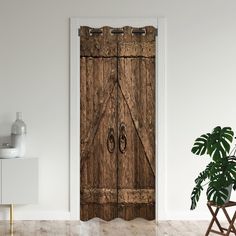 an open wooden door in a white room