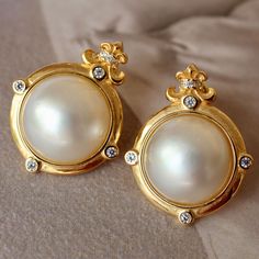 These stunning gold plated silver earrings feature a beautiful pair of hemisphere Mabe Pearl stones. With their intricate details and rich color, these push back studs are the perfect statement piece for any outfit. Handcrafted with care, these earrings are a true work of art and are sure to draw attention wherever you go. Whether you're looking for a unique gift or simply want to treat yourself. With their durable construction and timeless design, they're sure to become a beloved addition to yo Luxury White Clip-on Diamond Earrings, Luxury Diamond Earrings With Cabochon, Luxury Diamond Cabochon Earrings, Luxury Round Cabochon Earrings, Classic White Gold Clip-on Earrings For Formal Occasions, Elegant Formal Clip-on Diamond Earrings, Luxury Clip-on Earrings With Diamond Accents For Formal Occasions, Luxury Round Clip-on Diamond Earrings, Luxury Round Cabochon Clip-on Earrings