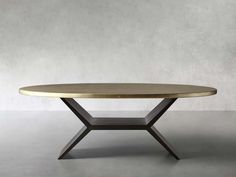 an oval table with a metal base and wooden top