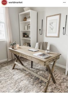 a wooden table sitting on top of a rug next to a book shelf filled with books