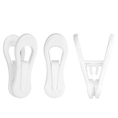 three white plastic objects are lined up on a white surface, one is holding a pair of scissors and the other has two handles