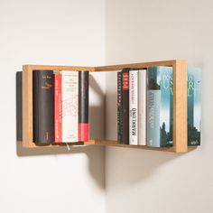 a book shelf with several books on it and a light hanging from the wall behind it