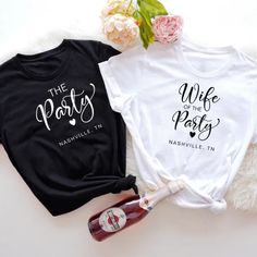 two t - shirts with the words wife and husband printed on them next to a bottle of wine