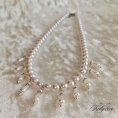 This beautiful necklace was inspired by portraits of the 18th Century, Pearl loving French Queen. Featuring 10 Pearl drops suspended from a uniform string of Pearls at equal intervals, it hangs delicately over the d'ecolletage. The drop pendants themselves feature a teardrop shaped Pearl topped with a rhinestone spacer and a smaller Pearl bead. This necklace can be made in either gold or silver, and measures 17 inches in length and has a 2 inch extender chain for a more flexible fit. Marie Antoinette Style, Pearl Love, Pearl Drop Necklace, String Of Pearls, Wedding Jewellery Necklace, Freshwater Cultured Pearls, Marie Antoinette, Drop Necklace, Drop Pendant