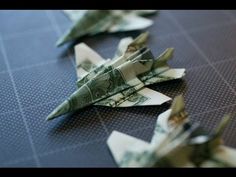 dollar bill origami fighter jets sitting on top of each other