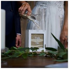 a bride and groom pouring wine into glasses