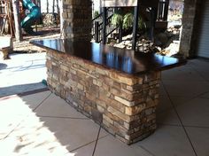 an outdoor patio with stone walls and columns