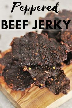 a wooden cutting board topped with brownies on top of a white tablecloth and text overlay that reads peppered beef jerry