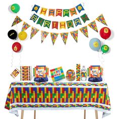 a birthday party with balloons and streamers on the wall, table cloths and decorations