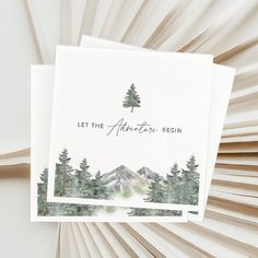 two greeting cards with the words let the adventure begin on them and trees in the background