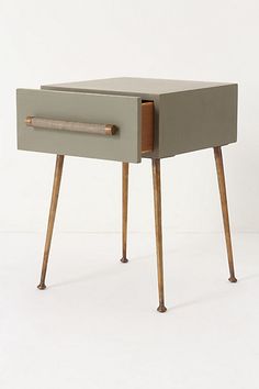 a small wooden table with two drawers on one side and an open drawer on the other