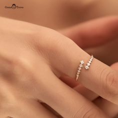 a woman's hand with a diamond ring on it