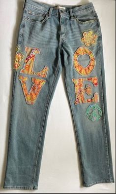 a pair of jeans with the word love painted on them