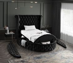 a black bed with white sheets and pillows in a room next to a large window