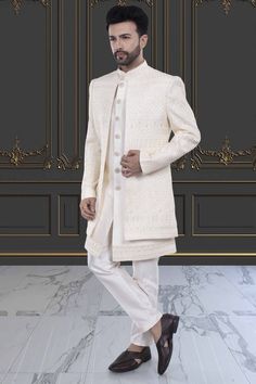 Indulge in luxury and sophistication with our Mens Sherwani- U2-S382. This open jacket sherwani is perfect for special occasions, showcasing your refined and elegant taste. Elevate your style and make a statement with this premium piece. Luxury Bandhgala For Groom, Elegant Semi-formal Sets For Eid, Elegant Front Open Sets With Dabka Work, Elegant Cream Bandhgala With Chikankari Embroidery, Cream Chikankari Embroidered Sherwani For Formal Occasions, Elegant Traditional Wear With Naqshi, Elegant Traditional Wear With Naqshi Drape, Elegant Traditional Wear With Naqshi In Traditional Drape, Long Nehru Jacket With Dabka For Wedding