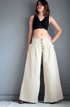 "This 4 size pants is made of 100% cotton fabric. Simple in design, gathered front, with zipper and 5 buttons. Elastic in the back for flexibility. Low waist design. Super cute pocket on both sides feathering fan shape gathering. Long wide leg. Elegant piece.Flattering to most shape. Measurement; S Low waist max 28-36\" Hip max 42\" Length out seam 39\" Length inseam 30\" M Low waist max 36-39\" Hip max 44\" Length out seam 40\" Length inseam 31\" L Low waist max 39-40\" Hip max 46\" Length out High Waist Beige Cotton Harem Pants, High-waisted Cotton Harem Pants In Beige, Beige High-waisted Cotton Harem Pants, Relaxed Fit Cotton Wide Leg Pants With Button Closure, Cotton Wide Leg Pants With Button Closure, High Waist Linen Bottoms With Buttons, Cotton Wide-leg Pants With Button Closure, High-waisted Cotton Harem Pants, Cotton Wide Leg Full Length Pants With Button Closure