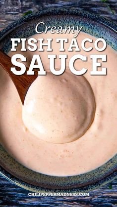 creamy fish taco sauce in a bowl with a wooden spoon on the side