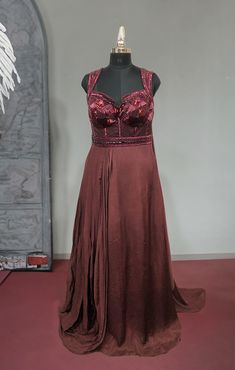 Look simply stunning in this designer Maroon Color Chiffon gown. It is embellished with stone, and Cutdana work all over. Highlight of the gown is the Beautiful Embroidered Neck Design. Slight variation in color, fabric & work is possible. Pictures shown are for illustration purpose only. NOTE: Originally stitched in size 42 but can be altered for size 40 without any extra cost. Style: Gown Fabric: Chiffon, Net Work: Stonework, Sequins Work, Cutdana Colour: Maroon Length: 62 Chest: 42 Waist: 32 Embellished Floor-length Evening Dress With Fitted Bodice, Floor-length Evening Dress With Embellished Fitted Bodice, Floor-length Georgette Gown With Sheer Bodice, Fitted Georgette Gown With Sheer Bodice, Fitted Gown With Sheer Bodice In Georgette, Embellished Georgette Evening Dress, Floor-length Georgette Gown With Fitted Bodice, Floor-length Georgette Evening Gown, Fitted Georgette Prom Gown