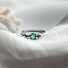 a close up of a ring on a white cloth