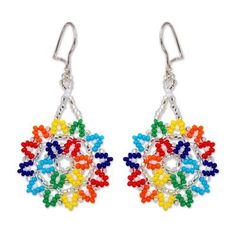 Mexican artisan Adriana Trejo uses shimmering and multicolored petite glass beads to diligently handcraft two stars that dangle from the ears with brilliance. Hanging from hooks of sterling silver these dangle earrings add an otherworldly aesthetic to your wardrobe. Multicolor Sterling Silver Jewelry With Tiny Beads, Ornate Multicolor Beaded Sterling Silver Jewelry, Multicolor Czech Glass Dangle Earrings, Silver Sterling Beaded Earrings With Colorful Beads, Silver Earrings With Tiny Beads, Silver Sterling Silver Earrings With Colorful Beads, Multicolor Dangling Beads Jewelry Made Of Czech Glass, Colorful Beaded Earrings In Sterling Silver, Artisan Silver Beaded Earrings With Multicolor Beads