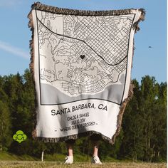 a person standing in front of a large white blanket with a map on it that says santa barbara, ca