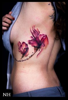 a woman's breast with pink flowers on her stomach and the words, i love you