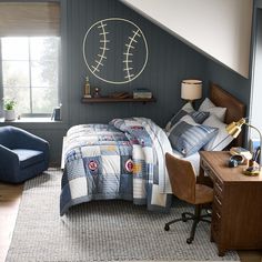 a bed room with a neatly made bed next to a desk and chair in front of a window