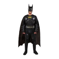 a man dressed as batman standing in front of a white background