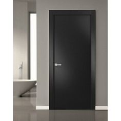 an empty room with a black door in it