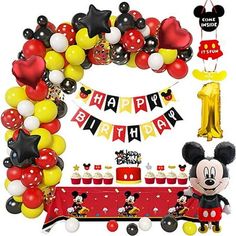 a mickey mouse birthday party with balloons and decorations