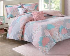 a pink and blue comforter set with hearts on it