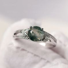 a close up view of a ring with a green stone