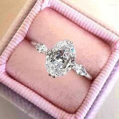 a diamond ring in a pink velvet box