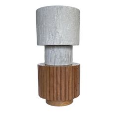 a lamp that is on top of a wooden base and has a white shade over it