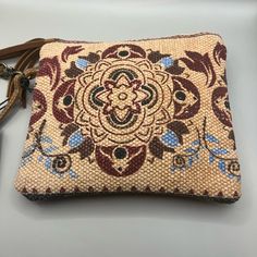 This Myra Bag Women's Canvas Purse In The "Lurantis" Pouch Style Is A Versatile And Stylish Addition To Any Outfit. With A Small Size Of 8.5" X 7.5", It Can Be Used As A Wristlet For Casual Occasions. The Bag Features A Beautiful Floral Pattern And Is Made Of Canvas And Leather Materials, With Gold Hardware Accents And A Brushed Finish. The Wrist Strap Is Brown In Color And Measures 5 Inches In Drop Length. The Bag Has A Zip Closure And Is Lined With Canvas And Leather Materials In A Brown Color Natural Pouch Shoulder Bag For On-the-go, Beige Tote Pouch For Daily Use, Leather Handle Pouch Clutch For Travel, Brown Tote Pouch With Adjustable Strap, Everyday Leather Handle Pouch Clutch, Brown Zipper Pouch For Daily Use, Brown Rectangular On-the-go Pouch, Rectangular Beige Pouch For Daily Use, Beige Handheld Pouch For Daily Use