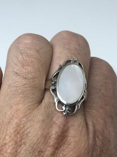 Lovely polished sterling silver has the look of Deco with a huge white Mother Of Pearl set in very detailed vintage filigree Size 7.75 We can size these with an additional $10-$20 fee for the jeweler All rings are shipped in a nice gift box. Check out our over a THOUSAND great reviews Engraving is $4 per letter and is not always perfect depending on the piece. It can take a few days if the jeweler is busy. This is payable to Paypal Judithsltd@gmail.com Antique White Moonstone Wedding Ring, Vintage White Gold Moonstone Ring For Formal Occasions, Heirloom White Moonstone Ring For Formal Occasions, White Moonstone Ring With Polished Finish, Antique White Hallmarked Moonstone Ring, Elegant Jewelry With Intricate Design And Oval Cabochon, Elegant Oval Cabochon Engraved Rings, White Oval Cabochon Jewelry, White Filigree Jewelry For Formal Occasions