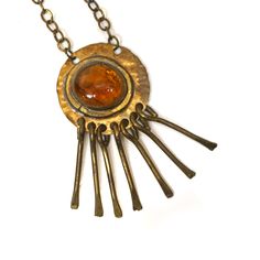 "A hand crafted modernist necklace in brass with dangle decor and glass pendant by Rafael Alfandary. Some tarnishing to chain. Signed on back on pendant. Length (pendant): 3\" Width (pendant): 1-1/2 Length (chain): 16\"" Vintage Hand Forged Brass Jewelry, Retro Brass Pendant Jewelry, Vintage Hand Forged Metal Necklace, Retro Brass Dangle Jewelry, Retro Soldered Metal Jewelry, Artisan Soldered Brass Necklaces, Handmade Brass Modernist Jewelry, Handmade Modernist Brass Jewelry, Bohemian Brass Collectible Necklace