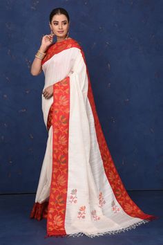 Elegant off-white matka silk sari for an understated yet striking festive look! The saree has a cut shuttle red weave border. It comes with a matching blouse piece. Shop silk sarees in USA from Pure Elegance. The shown stitched blouse on the model is for display purpose only. The saree comes with a matching blouse piece and finished with fall and piko. White Cotton Silk Pre-draped Saree For Festivals, Traditional White Pre-draped Saree With Embroidered Border, White Cutdana Pre-draped Saree For Puja, White Handloom Pre-draped Saree For Diwali, Pre-draped Saree With Embroidered Border In Slub Silk, Slub Silk Pre-draped Saree With Embroidered Border, White Handloom Pre-draped Saree, Wedding Slub Silk Pre-draped Saree With Embroidered Border, White Slub Silk Dupatta With Embroidered Border