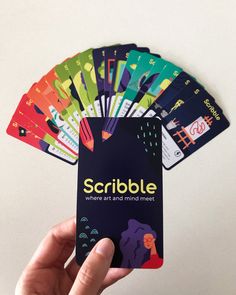 a hand holding a card with the words scribble on it