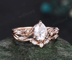 a rose cut diamond ring on top of a rock