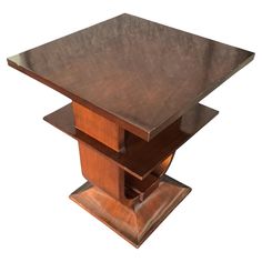 a square wooden table with three sections on each side and one section at the top