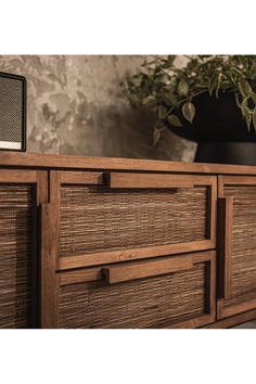 a close up of a wooden dresser with drawers and a radio on top of it