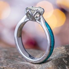 a close up view of a diamond ring on a rock